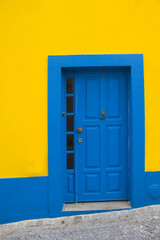 Blue door on the yellow wall