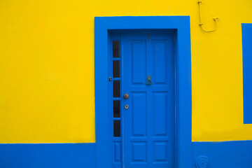 Blue door on the yellow wall