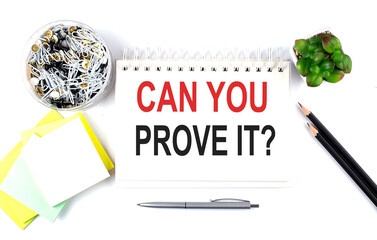 CAN YOU PROVE IT text on notebook with office supplies on white background - obrazy, fototapety, plakaty