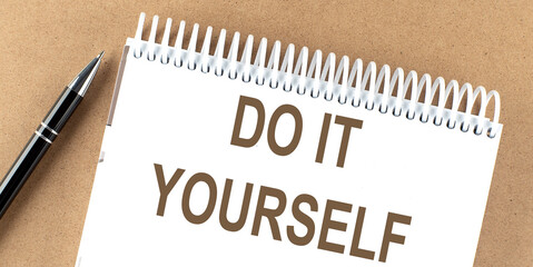 DO IT YOURSELF text on a notepad with pen, business concept