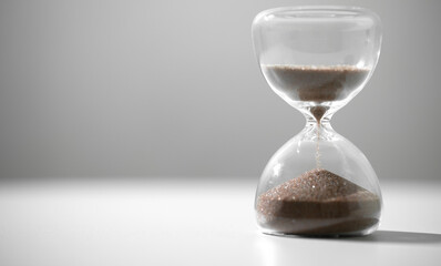  hourglass (sand clock) on the white table, Hourglass as time passing concept for business deadline, Life-time passing concept, elapsed time concept, with copy space