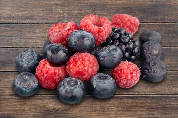 Fresh raspberries, blackberries and blueberries ion the table