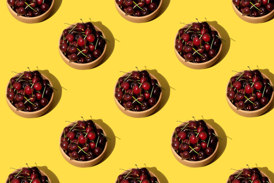 Cherries repetition pattern on yellow background