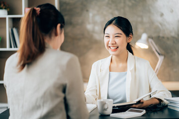 Business women using calculator at working with financial report.