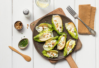 pear ricotta salad with lettuce on wooden table