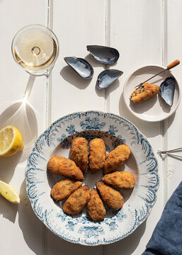 Fresh stuffed mussels in a bowl on wooden table