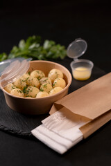 new potatoes with greens in a cardboard box food delivery