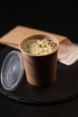 summer soup okroshka in a cardboard glass food delivery