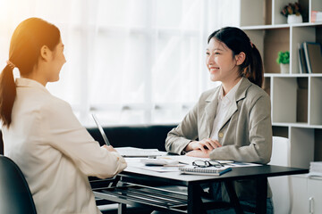 Business women using calculator at working with financial report.