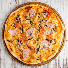 delicious hot traditional italian pizza on a white wooden rustic background