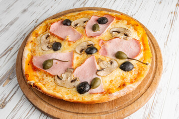 delicious hot traditional italian pizza on a white wooden rustic background