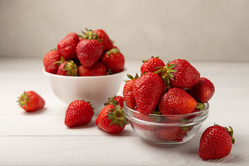 Fresh ripe strawberries in a plate on a white wooden background.Vegetarian organic berry.Healthy food.Vitamins.Copy space.Space for text