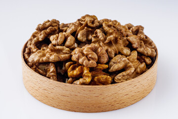 dried walnuts on a white acrylic background
