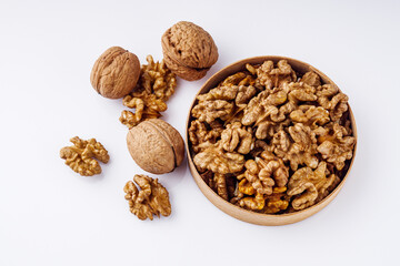 dried walnuts on a white acrylic background