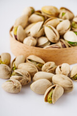 fresh salted pistachios on a white background