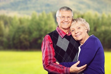 Perfect happy senior couple going for a walk in the park.