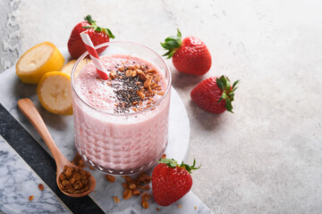 Strawberry smoothie. Vegan smoothie or milkshake from strawberry, banana and mint on white wooden table background. Clean eating, alkaline diet. Top view. Mock up.