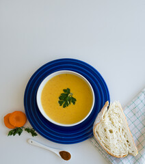 Carrot soup on a white background directly above