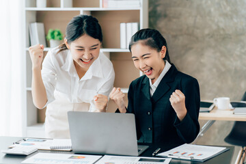 Asian businesswoman in formal suit in office happy and cheerful during using smartphone and working