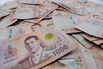 Close-up a pile of one thousand Thai Baht (THB) banknotes of Thailand. Cash of thousand baht bills, Background image with high resolution.
