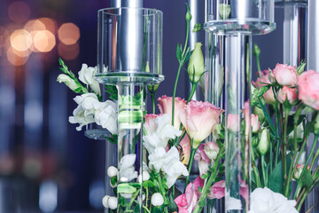 close-up of flowers and glass candlesticks. Banquet decor.