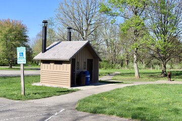 The old wood shack at the park on a sunny day.