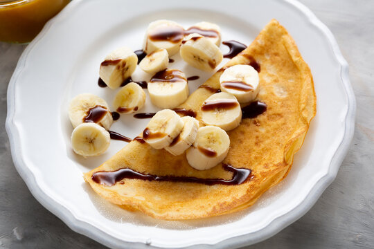 Breakfast crepes with banana and chocolate sauce pancake food