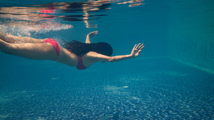 At the pool, Asian women are diving. She had on a bikini.
