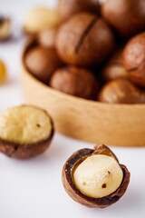 fresh macadamia nuts on a white acrylic background