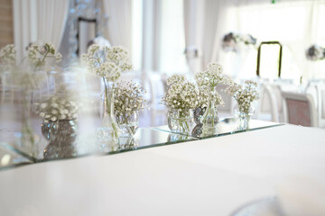 Main table at a wedding reception with beautiful fresh flowers