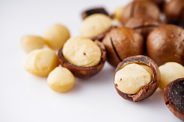 fresh macadamia nuts on a white acrylic background