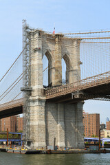 Naklejka premium Famous Brooklyn Bridge (fragment), hybrid cable-stayed, suspension bridge, in background of blue sky