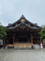 The main pagoda of Yushima Tenjin, the historic establishment in 458 the beautiful architecture with plum symbolic family crest “Kamon”.  Photo taken year 2022 June 15th