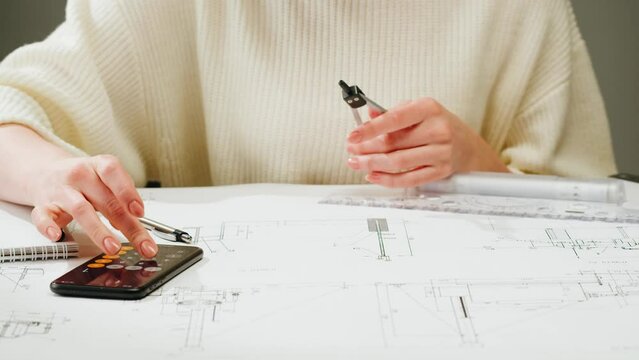 Architect designer counting on a calculator, drawing plan blueprint close-up. Professional engineer working, interior creator making architectural house project, drafting building.