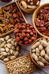 Fototapeta premium set of different nuts on a white wooden rustic background