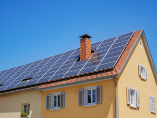 home with solar energy green plants and sunny blue sky