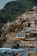 Fototapeta na wymiar Panoramic views of Positano in the Amalfi Coast in Italy. The view of Positano town, colorful buildings, roads, boats and the sea.