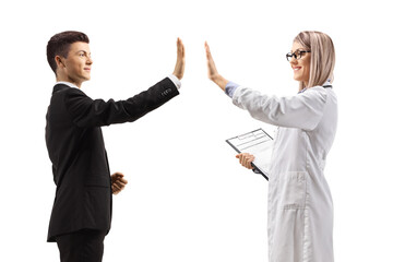 Young man in a suit and a female doctor gesturing high-five