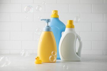 Baby liquid soap and washing gel with yellow duck in the bathroom and flying soap bubbles....