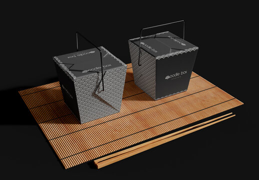 Noodle Boxes with Chopsticks on a Bamboo Mat