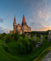 Fototapeta na wymiar Beautiful summer sunset at Corvin (Hunyad) Castle in Hunedoara, an amazing landmark from Transylvania, one of the biggest castles in Europe. Travel to Romania.