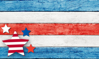 4th of July decorative elements stars stripes on a red and blue wooden background