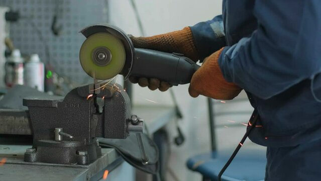 Man works circular saw. Flies of spark from hot metal. The man's hard work. Man Chlef and smooth surface. Man worked over the steel. close-up of hand and electric saws metal. Close-up of hand tool.