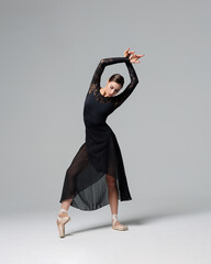 Elegant ballerina. A young graceful ballet dancer, dressed in pointes shoes demonstrates her dance...