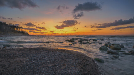 Colorful sunset on the sea rocky shore