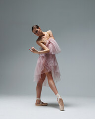 Elegant ballerina. A young graceful ballet dancer, dressed in pointes shoes demonstrates her dance skills. Power and refinement of classical ballet. © Alexander Y