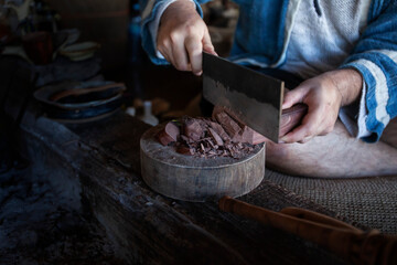 Shaman hand holding a sharp knife, chop the cacao.cacao ceremony