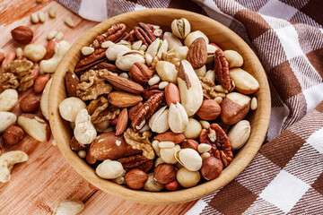 set of different nuts on a wooden rustic background
