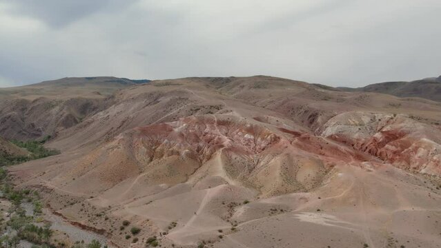 Red mountains landscape in Kyzyl-Chin valley also called as Mars valley in Altai, Siberia, Russia. Beautiful summer nature landscape at during daytime. Aerial view from a drone
