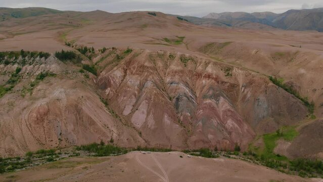 Red mountains landscape in Kyzyl-Chin valley also called as Mars valley in Altai, Siberia, Russia. Beautiful summer nature landscape at during daytime. Aerial view from a drone